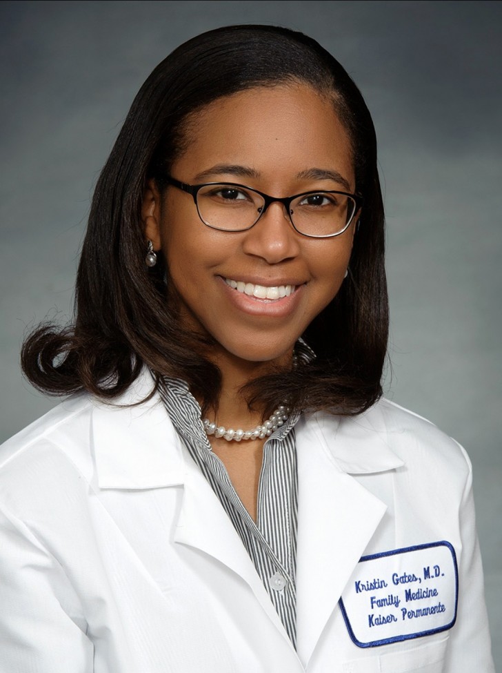 Portrait of a female African American doctor, wearing a white coat